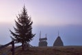 Amazing mountain landscape with fog and a haystack in autumn Royalty Free Stock Photo