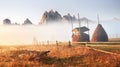 Amazing mountain landscape with fog and a haystack in autumn Royalty Free Stock Photo