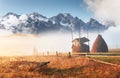 Amazing mountain landscape with fog and a haystack in autumn Royalty Free Stock Photo