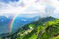 Amazing mountain landscape on sunny summer day with a rainbow in the sky Royalty Free Stock Photo
