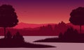 Amazing mountain view from the riverside at sunset with the silhouettes of pine trees all around Royalty Free Stock Photo
