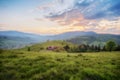 Amazing mountain view. wooden fence, rural road and high mountain village on sunset. summer landscape.  natural Royalty Free Stock Photo