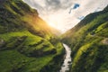 Amazing mountains covered green grass, river at sunset