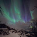 Amazing multicolored green Aurora Borealis also know as Northern Lights in the night sky over Lofoten landscape, Norway, Scandinav Royalty Free Stock Photo