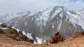 The amazing nature of Kyrgyzstan. Amazing mountain landscape. Panorama of red rocky cliffs and snow-capped mountains. Blue sky and Royalty Free Stock Photo