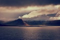 Amazing nature, night scenic landscape in moonlight with water, volcanic mountains and cloudy sky, Iceland. Travel outdoor