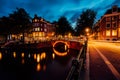 Amazing night in Amsterdam. Illuminated canal and bridge with typical dutch houses and bicycles, Holland, Netherlands Royalty Free Stock Photo