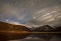 Stars tracks clouds sky mountains moonlight Royalty Free Stock Photo