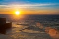 Amazing ocean sunset at the stone pier in calm weather. Nature. Royalty Free Stock Photo