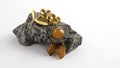 Amazing old orange amber Baltic brooch and golden vintage brooch on the natural stone.