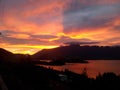 Amazing orange sky over the alpine mountains and the lake Wakatipu in Queenstown Royalty Free Stock Photo