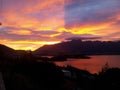 Amazing orange sky over the alpine mountains and the lake Wakatipu in Queenstown Royalty Free Stock Photo