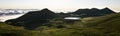 Amazing panorama landscape above the cloudline at Pico Island showing Lago de Peixinho Lagoa do Peixinho, green meadows and