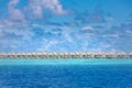 Luxury tropical beach resort, water villas over calm sea view. Exotic travel vacation seascape, landscape Royalty Free Stock Photo