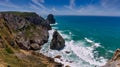 Amazing panorama of Rocky shore  Atlantic Ocean. View of high cliffs, foamy waves and sandy beach. Sunny summer seascape. Portugue Royalty Free Stock Photo