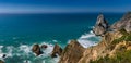 Amazing panorama of Rocky shore  Atlantic Ocean. View of high cliffs, foamy waves and sandy beach. Sunny summer seascape. Portugue Royalty Free Stock Photo