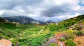 Amazing panorama of rough wild mountains, grass, cloudy blue sky, Lasithi, Crete