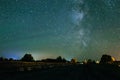 Amazing panorama of the stars of the night sky with the Milky Way over the village. starry sky. night shooting Royalty Free Stock Photo