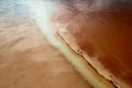 Amazing panoramic aerial landscape of beautiful salt plains. Salt lake. Bright red and orange salt deposits in artificial salt