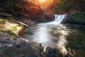 Amazing panoramic landscape mountain river in autumn forest at sunlight. View of stone water rapids and small waterfall. Royalty Free Stock Photo