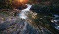 Amazing panoramic landscape mountain river in autumn forest at sunlight. View of stone water rapids and small waterfall. Royalty Free Stock Photo