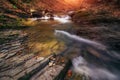 Amazing panoramic landscape mountain river in autumn forest at sunlight. View of stone water rapids and small waterfall. Royalty Free Stock Photo