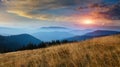 Amazing panoramic landscape in the mountains at sunrise. View of colorful sky and foggy hills covered by forest.