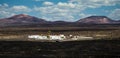 Amazing panoramic landscape of volcano craters in Timanfaya national park. Popular touristic village in La Gueria