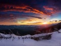 Amazing panoramic landscape in the winter mountains at sunrise . Dramatic morning sky. View of snow-covered trees and hills at dis