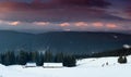 Amazing panoramic landscape  winter mountains at sunrise. View of dramatic overcast sky and distance snow capped peaks. Royalty Free Stock Photo