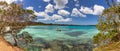 Amazing panoramic shot of Isle of Pines in New Caledonia. Beautiful turquoise water of the ocean with trees on the banks. Lone Royalty Free Stock Photo