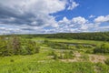 Amazing panoramic view of green summer landscape with forests, fields and river against blue sky and white clouds. Royalty Free Stock Photo