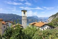 Panoramic view of the old historic bell tower in the resort village of Olcio at the shore of Como Lake in the Italian Alps mountai
