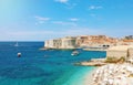 Amazing panoramic view of the old port of Dubrovnik with medieval fortifications on Adriatic Sea and Banje beach, Croatia, Europe