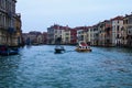 Amazing panoramic view over Grand Canal in Venice. Moored boats near colorful ancient buildings. Winter drizzle morning in Venice Royalty Free Stock Photo