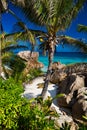 Tropical beach Anse Patates with palm trees and granite boulders on La Digue Island, Seychelles Royalty Free Stock Photo