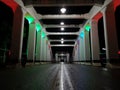 Amazing perspective and vanishing point with old white bridge at night, asphalt wet road surface