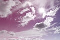 Amazing pink and purple sky with bright sun and fluffy clouds Royalty Free Stock Photo