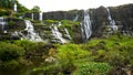 Amazing Pongour waterfall in Vietnam, Da Lat with the Buddha on the top.