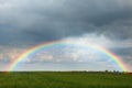 Amazing rainbow over green field Royalty Free Stock Photo