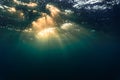 Rays of light shining through the surface of the atlantic ocean, into the deep, blue depths Royalty Free Stock Photo