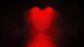 Amazing red studio spotlight . Stage with smoke reflection in water. Isolated on black background texture Royalty Free Stock Photo