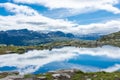 Amazing reflection over a lake in the mountains of Trolltunga hike,  Norway Royalty Free Stock Photo