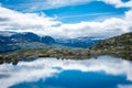 Amazing reflection over a lake in the mountains of Trolltunga hike,  Norway Royalty Free Stock Photo