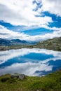 Amazing reflection over a lake in the mountains of Trolltunga hike,  Norway Royalty Free Stock Photo