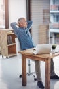 Amazing results come from doing more than you dream. a mature businessman taking a break at his office desk.