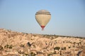 Hot air balloons fly in clear morning sky near Goreme, Kapadokya
