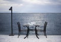 Amazing romantic dinner on the beach. Romance and love, dinning table setup with sea view in cloudy day