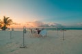 Amazing romantic dinner on the beach on wooden deck with candles under sunset sky. Romance and love, luxury destination dinning Royalty Free Stock Photo