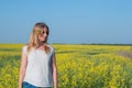 Amazing romantic girl in a field of yellow flowers